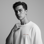 Person wearing a white t-shirt with a logo on a gray background