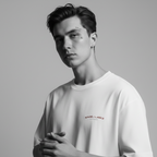 Person wearing a white t-shirt with a logo on a gray background