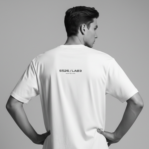 Person wearing a white t-shirt with 'SS26/LAB3' branding on the back, standing against a gray background.